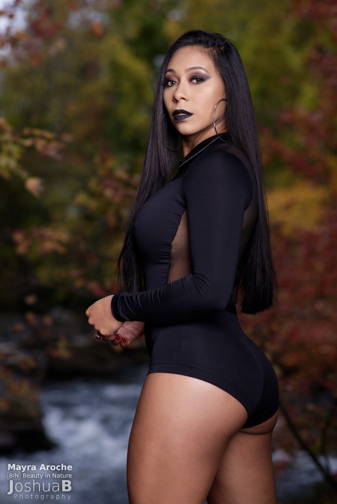 Sexy Latina from behind in Addams Family Halloween cosplay in fall foliage