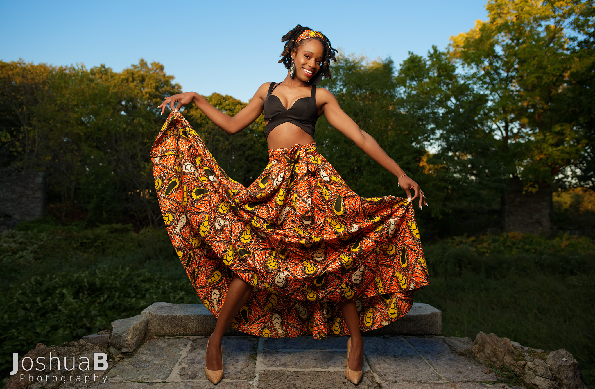 Beautiful black woman with dreadlocks modeling African print skirt in Boston