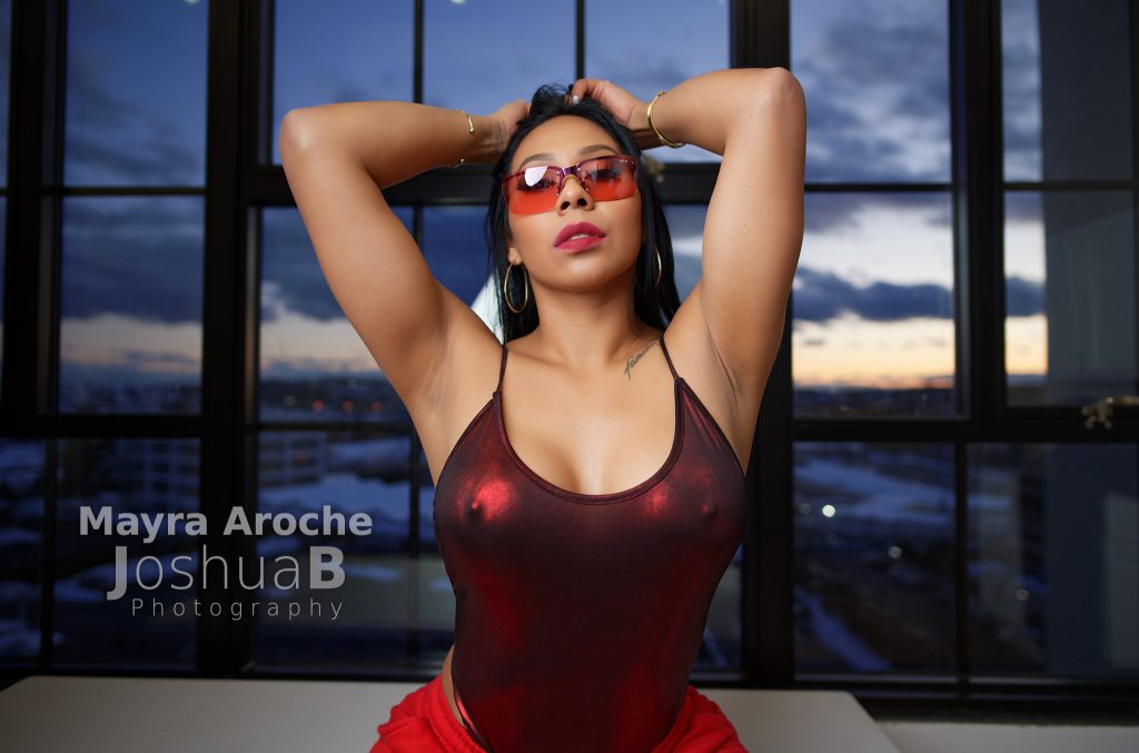 Mayra Aroche modeling in red bodysuit sunglasses